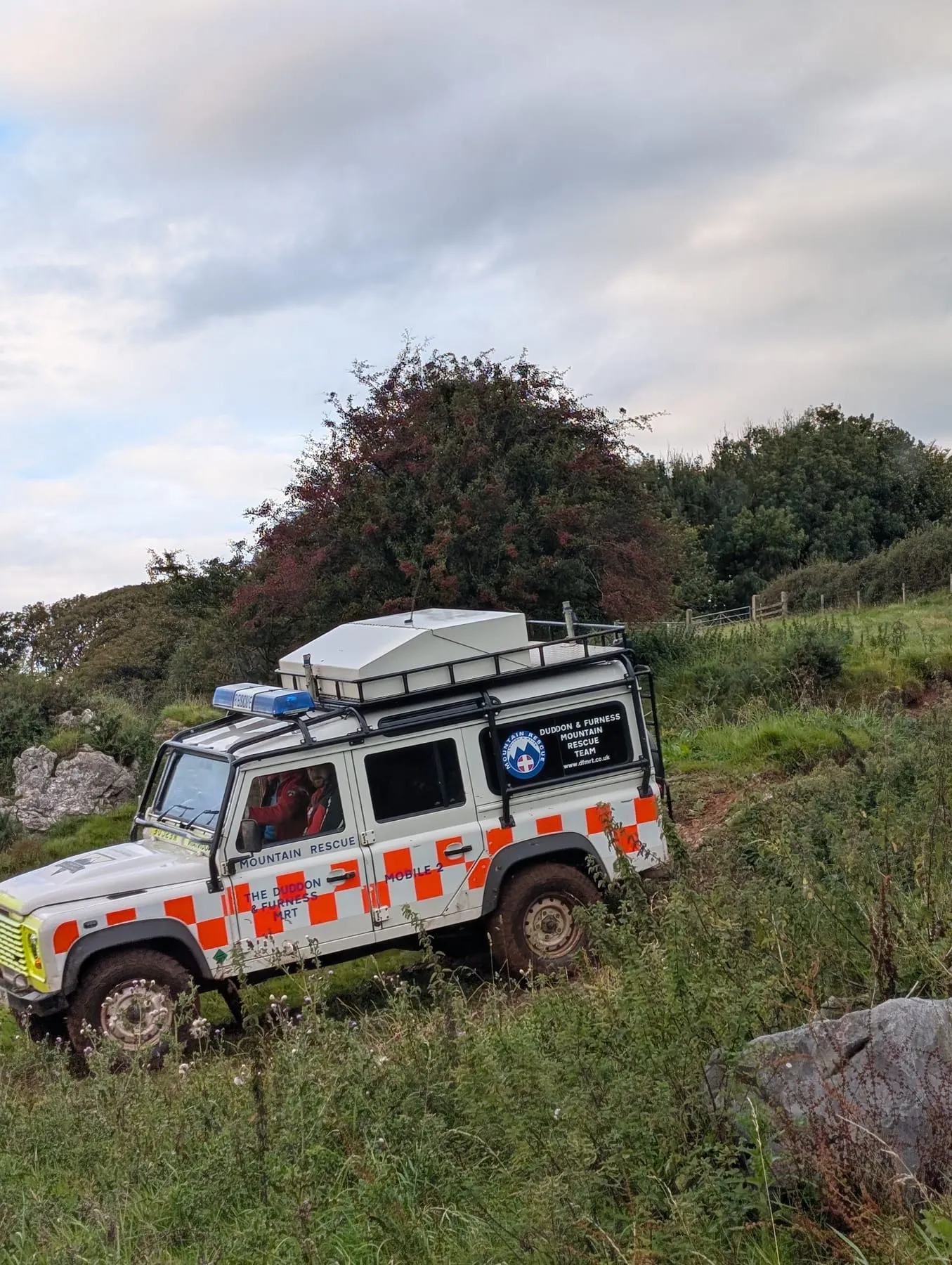 A team Land Rover on rough ground
