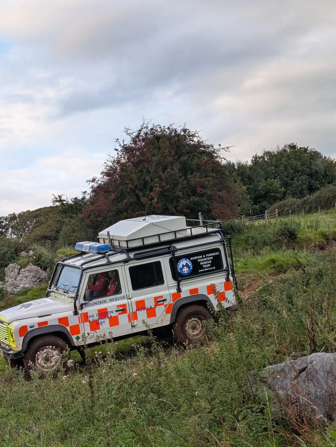 A team Land Rover on rough ground