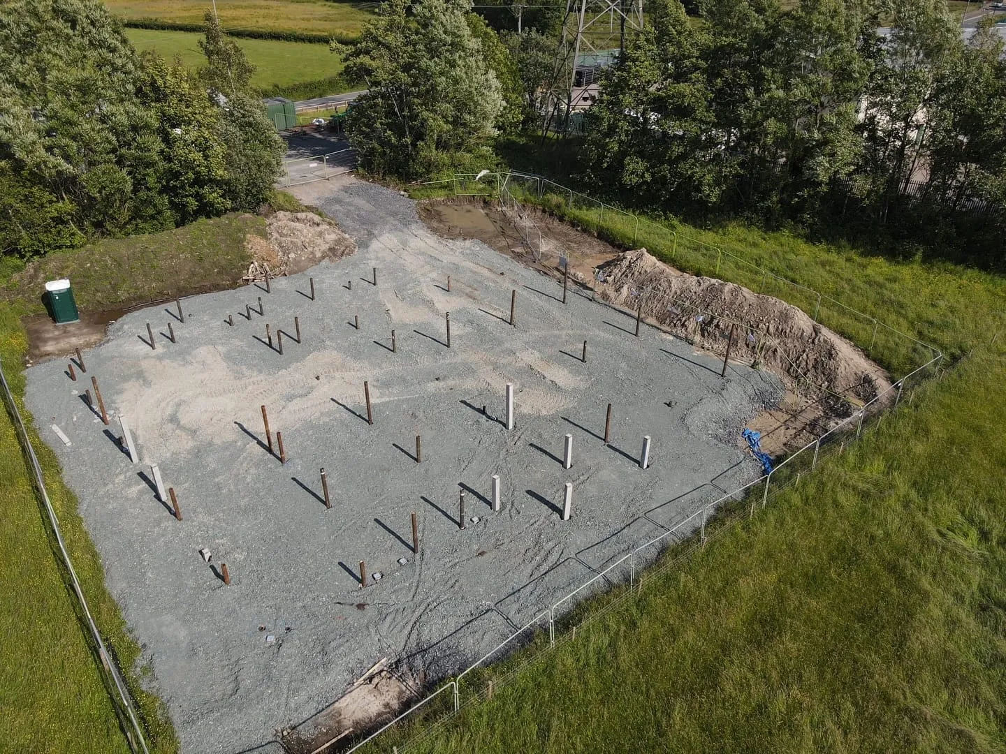 Piles set out across the gravel foundation of the new base