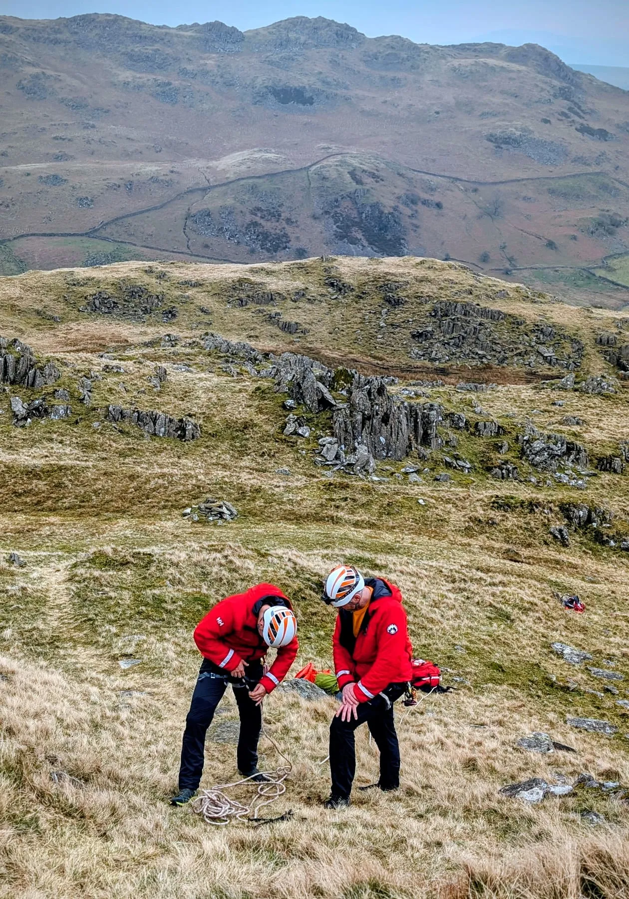 Two team members preparing ropes on a rocky fell